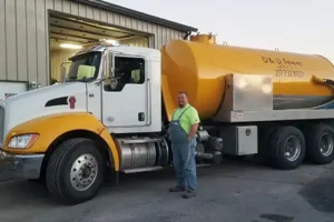 D&D Complete Sewer Service—A professional plumber stands by a truck in Central IL.